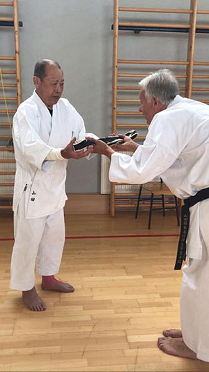 denis casey receiving obi from yamada